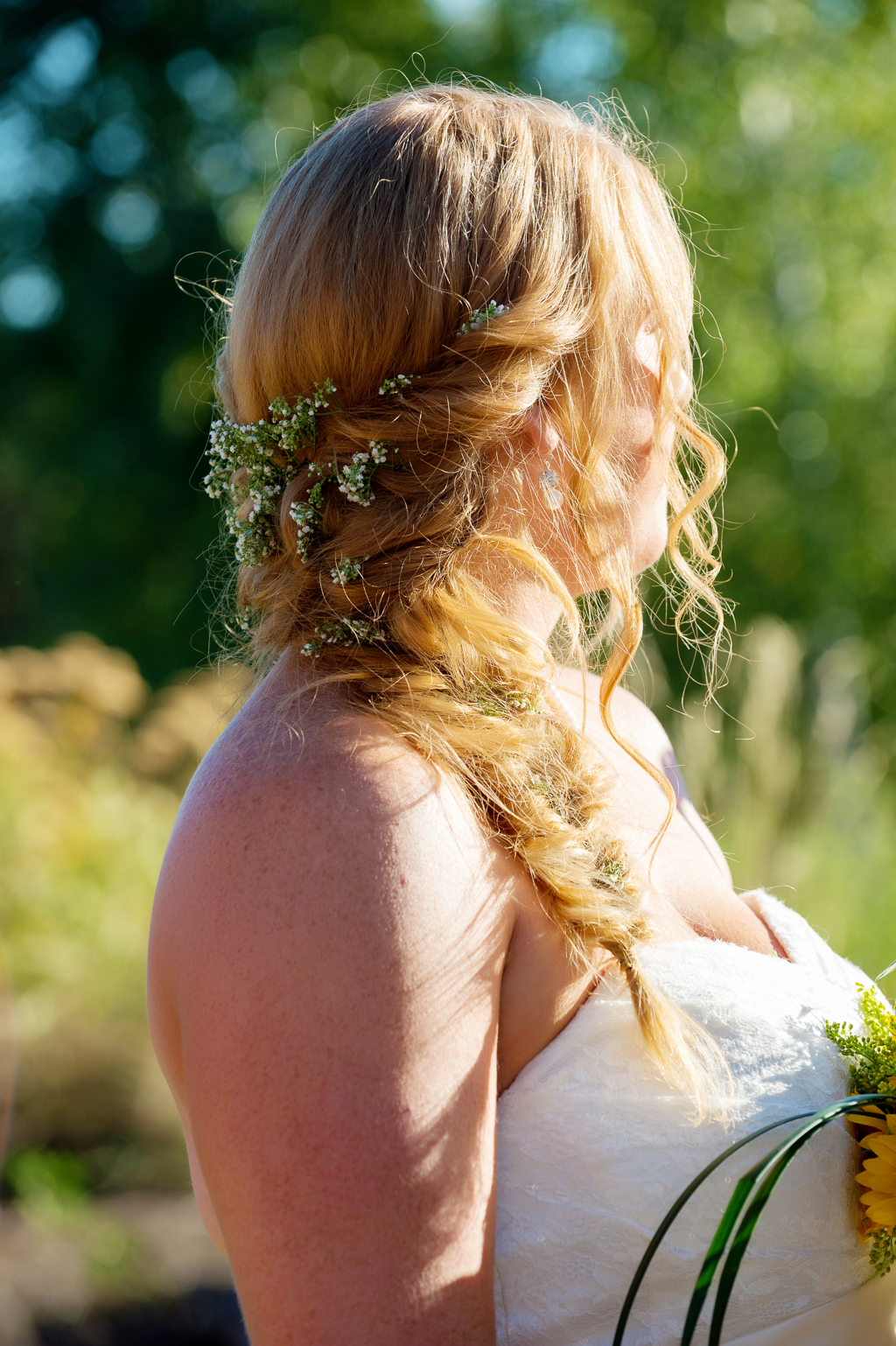 a bride wears a fishtail braid
