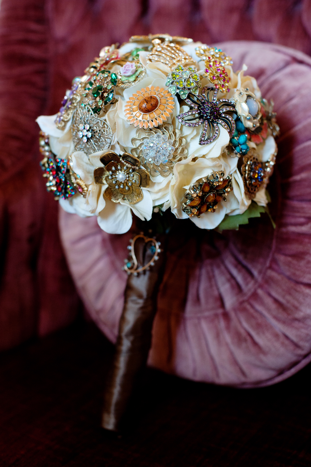 an ivory wedding bouquet filled with antique and vintage brooches