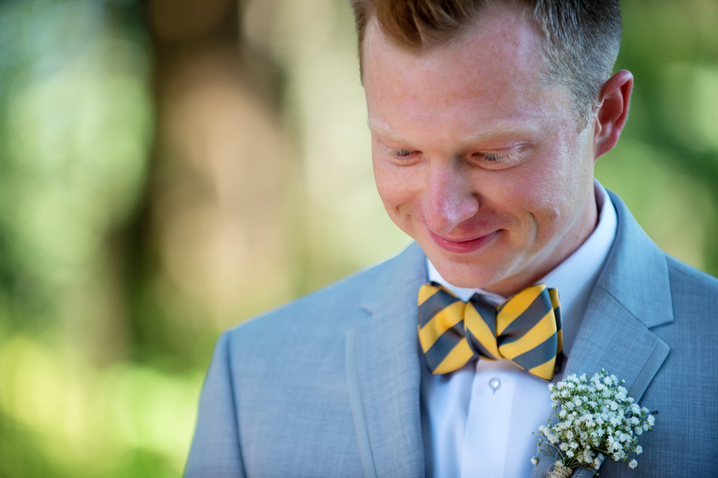 a groom wears a yellow and gray bowtie