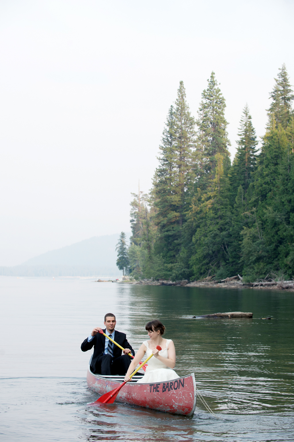 a bride and groom canoe at lake wenatchee