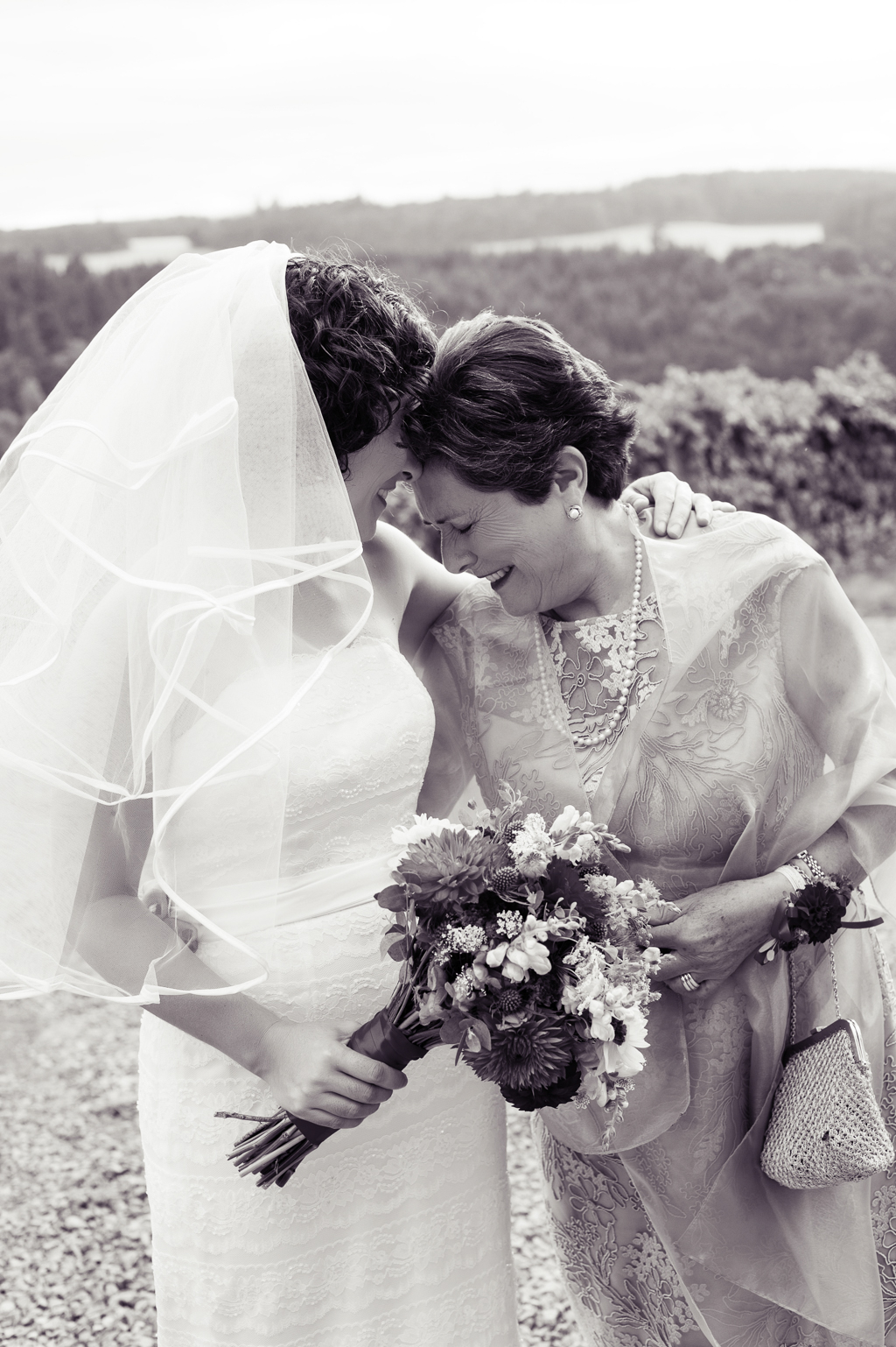 a bride and mother have a touching moment
