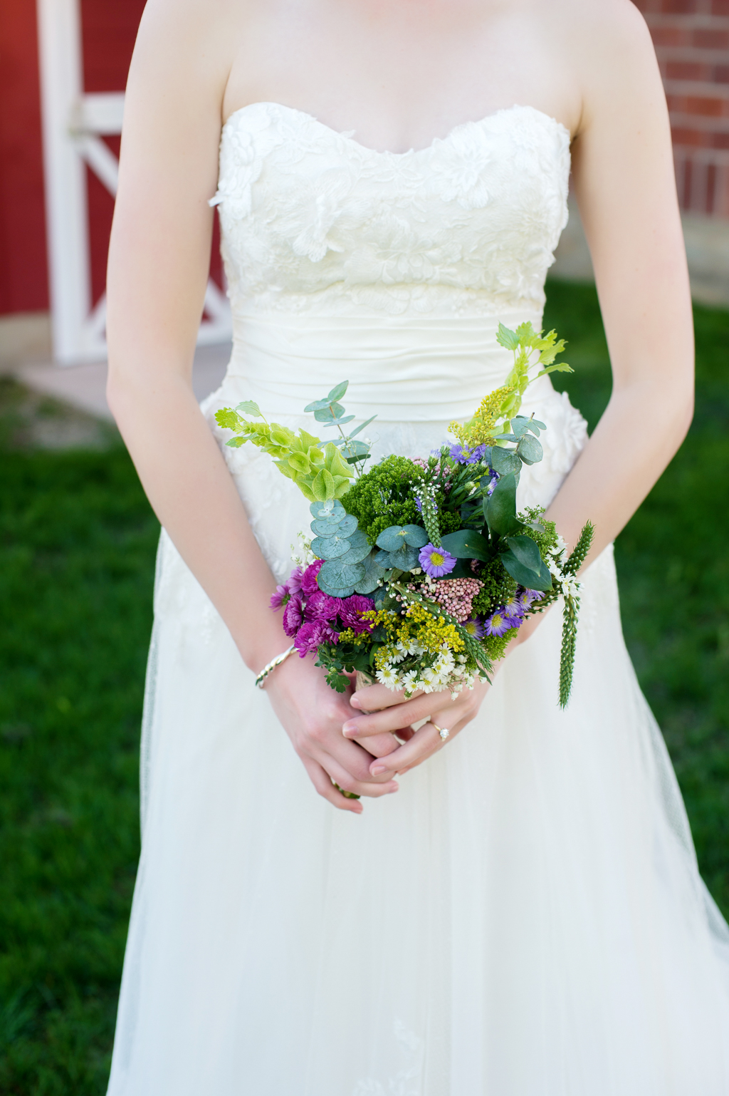 bride holds small colorful wildflower bouquet