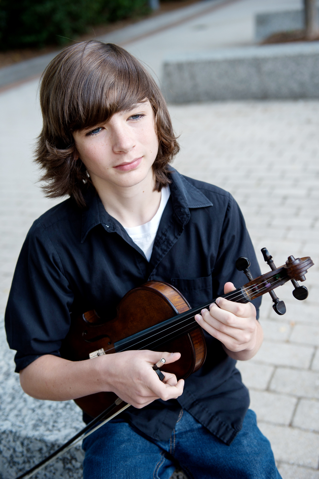 liam purcell of cane mill road holds his fiddle