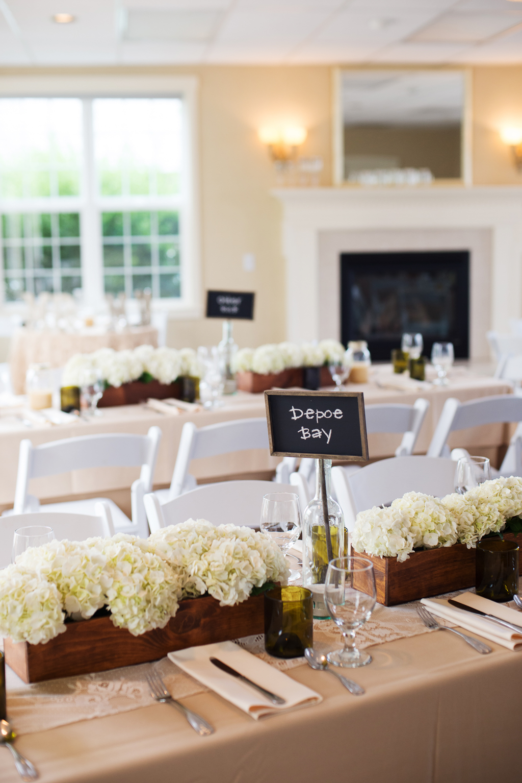 white florals line the tables at haystack gardens