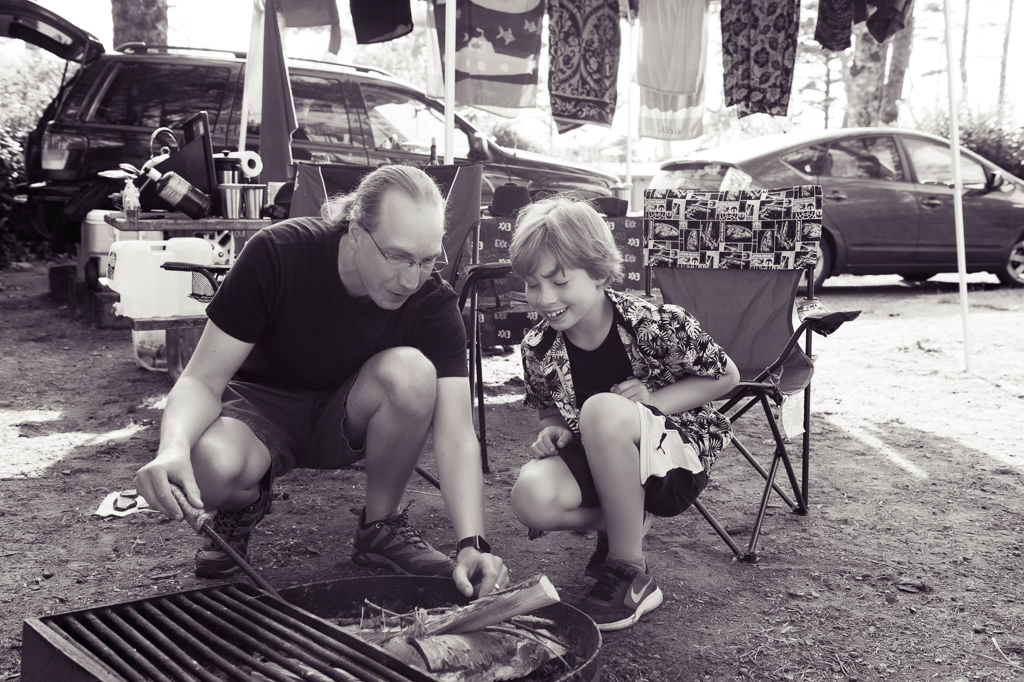 a dad shows his son how to make a campfire