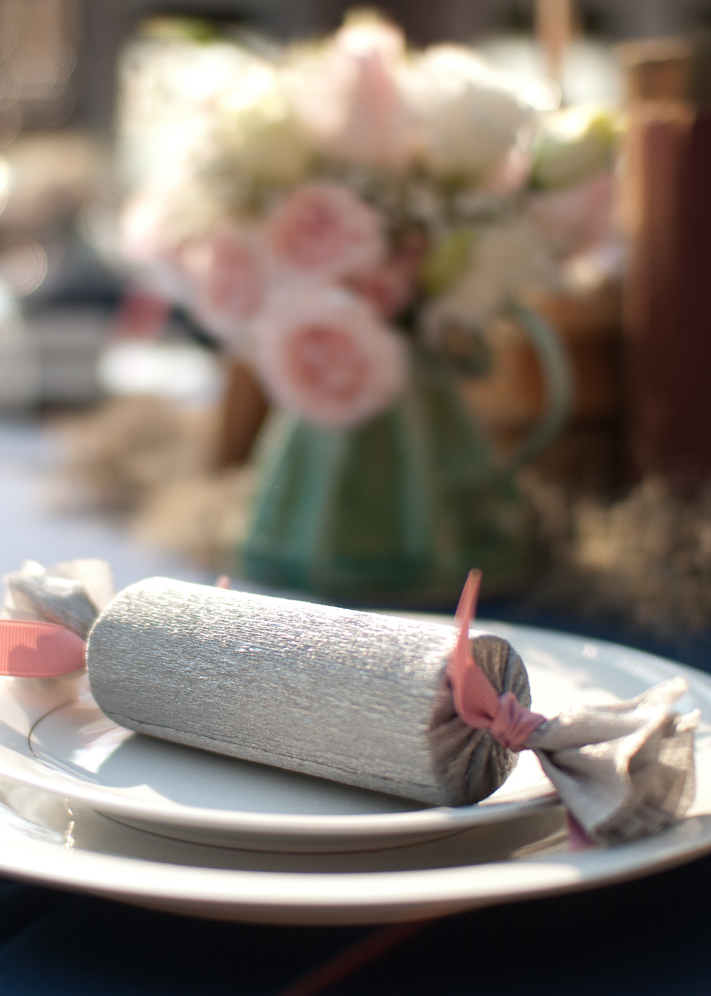 paper towel rolls covered in tissue paper and ribbon looks like candy and holds wedding guest favors