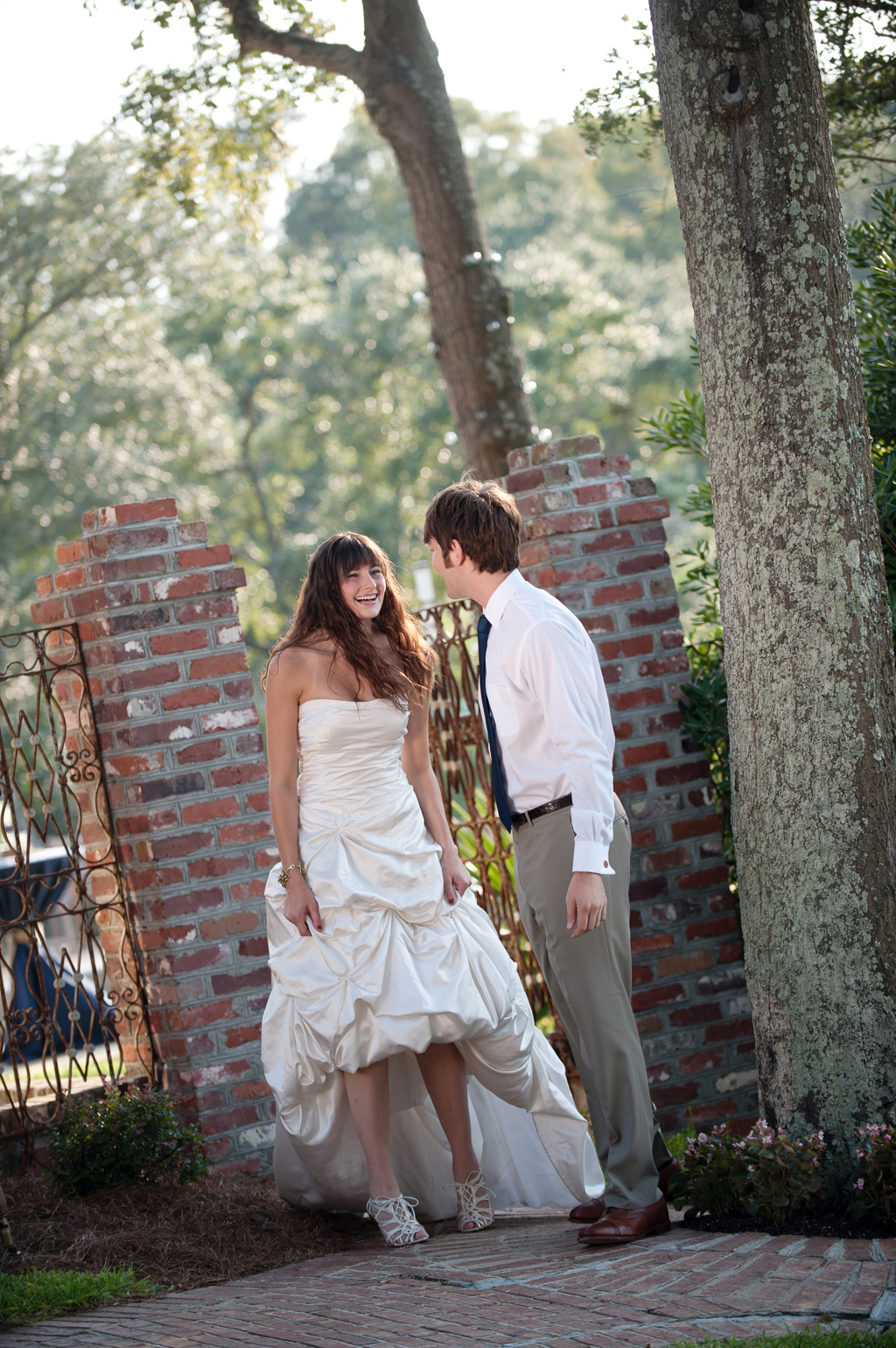 bride and groom have first look next to a wrought iron gate