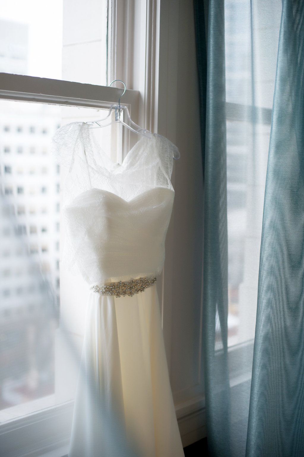 wedding dress hangs from the window at nines hotel