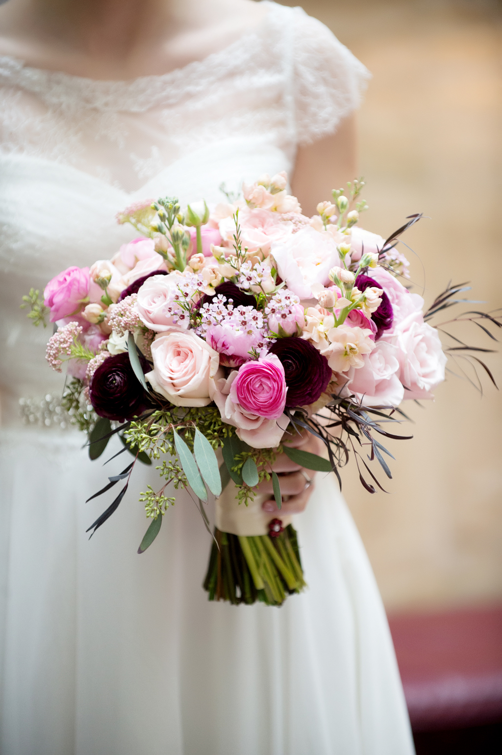 a pretty pink, peach, and maroon bouquet