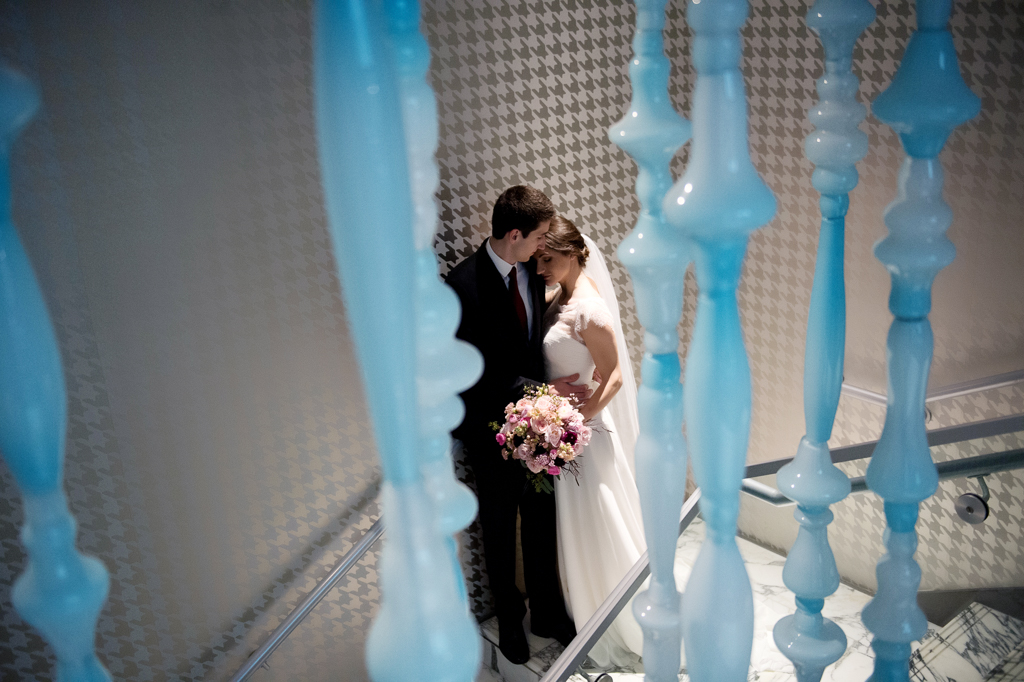 bride and groom embrace on the stairwell at the nines hotel