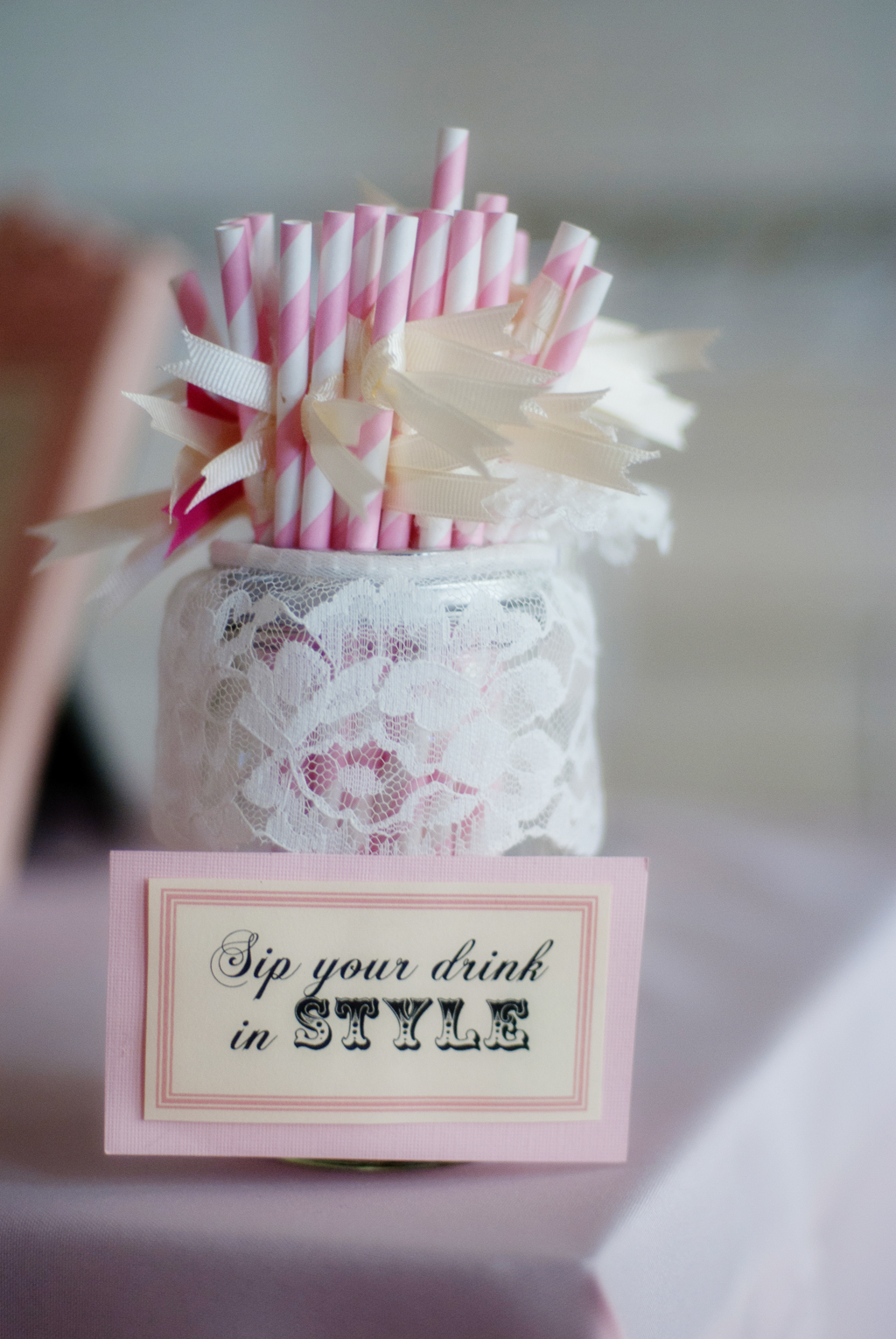 pretty lace jar filled with white and pink paper straws