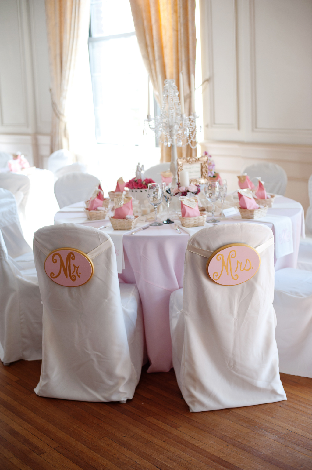 white covered chairs and pink covered tables at the hotel concord