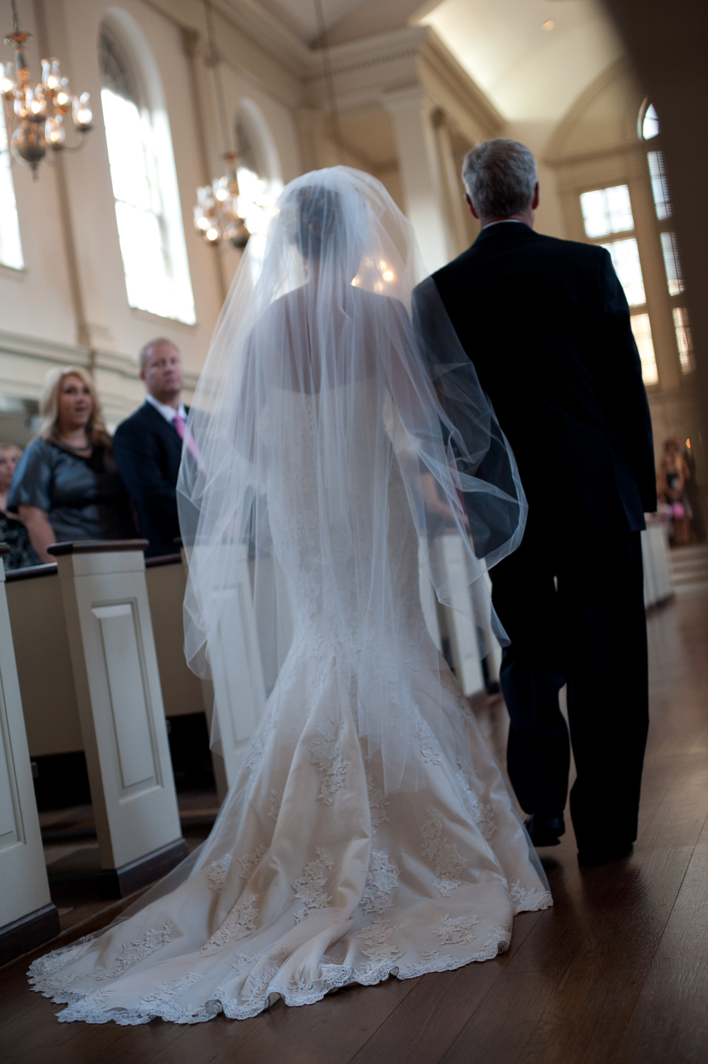 bride and father walk down the church aisle
