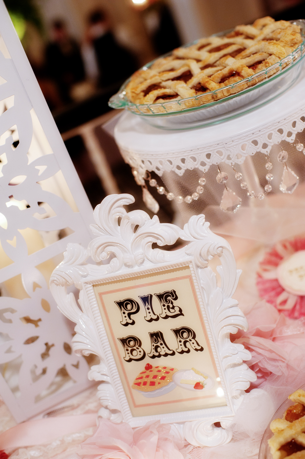 a sign says pie bar in front of pies at a wedding reception