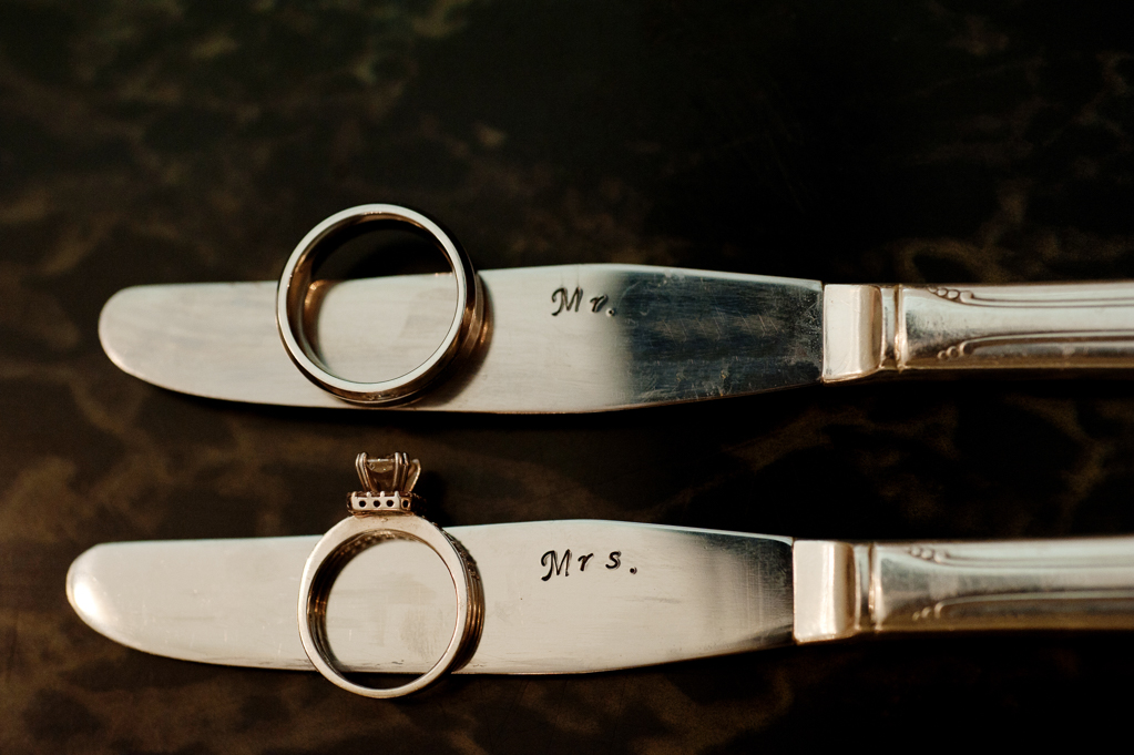 wedding rings on a set of knives that are engraved with mr. and mrs. 