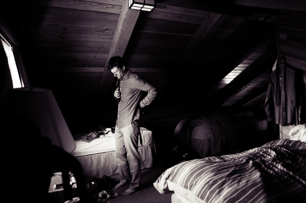 a groom gets ready in the attic of a cabin at cooper spur