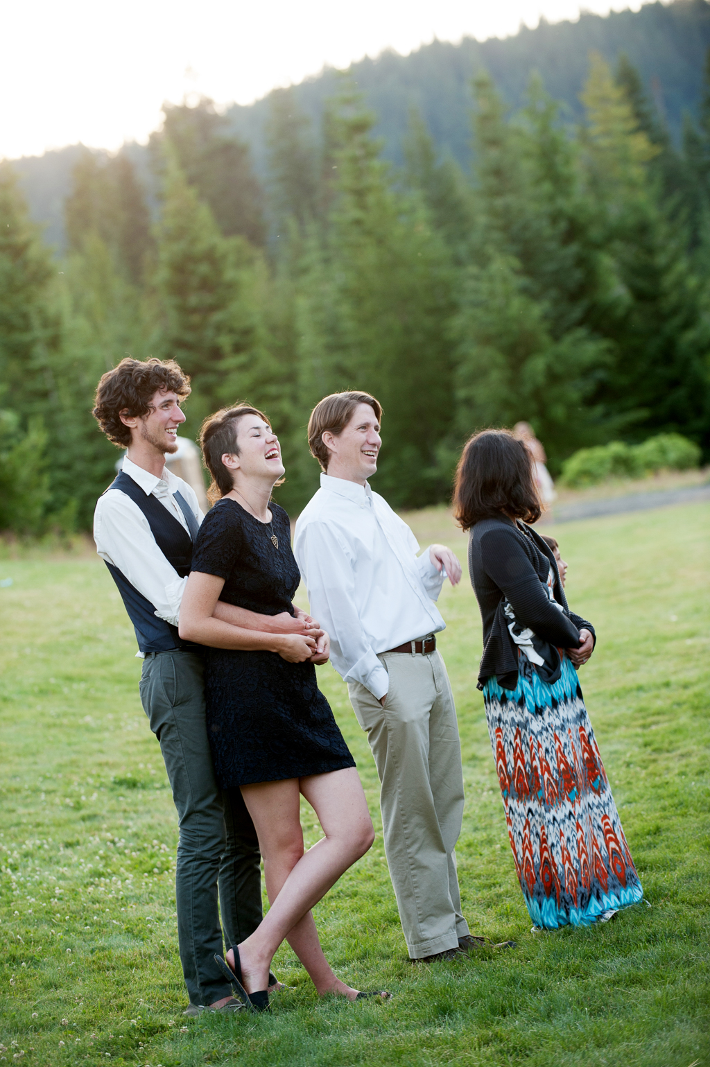 wedding guests stand in the lawn at cooper spur and laugh at reception toasts