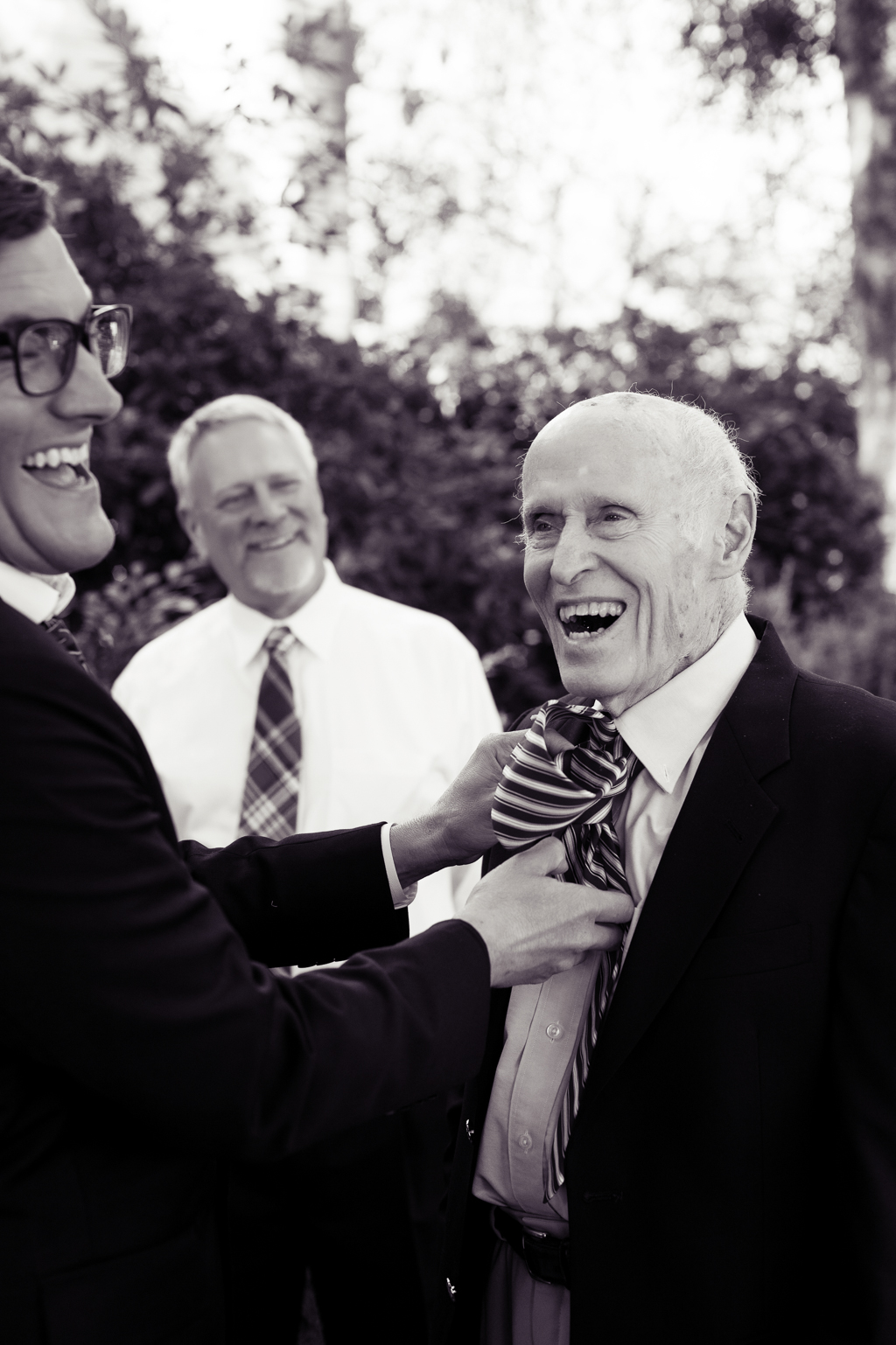 a groom helps tie his grandpas tie