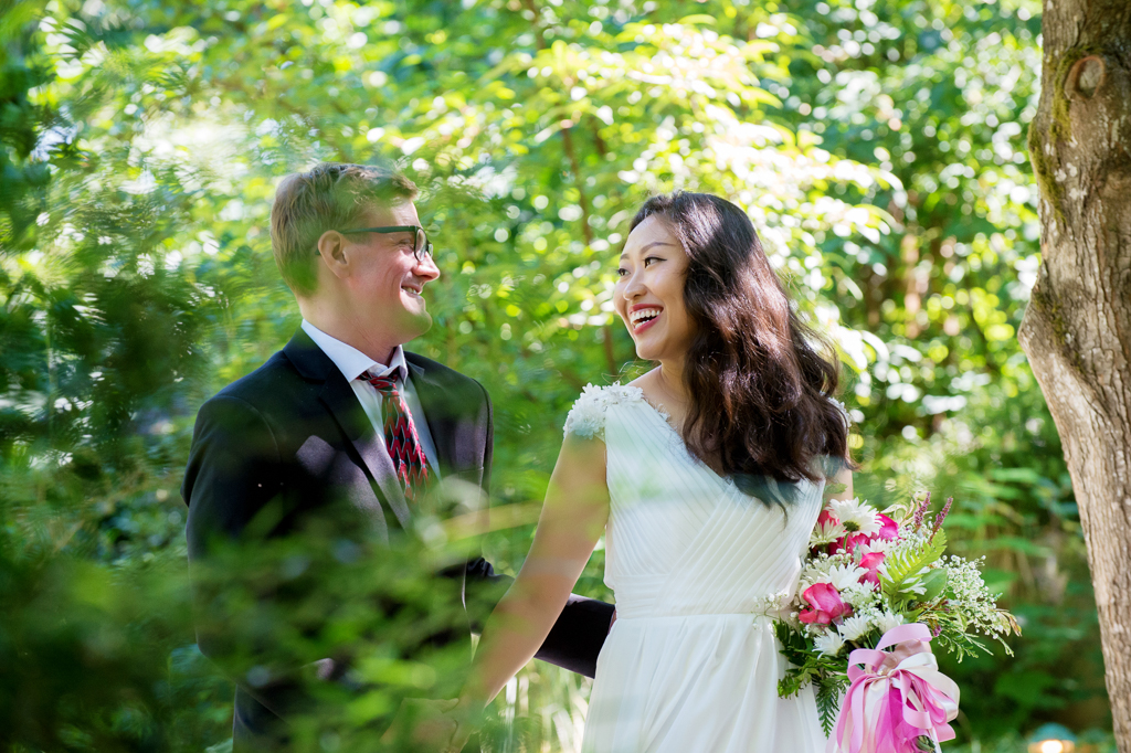 bride leads groom through a garden at cornelius pass roadhouse