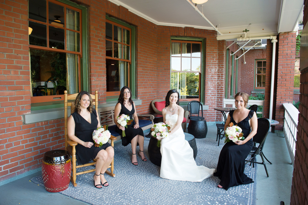 bride and bridesmaids sit on front porch of edgefield