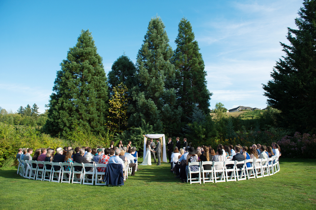 a wedding ceremony on the lawn at blackberry hall