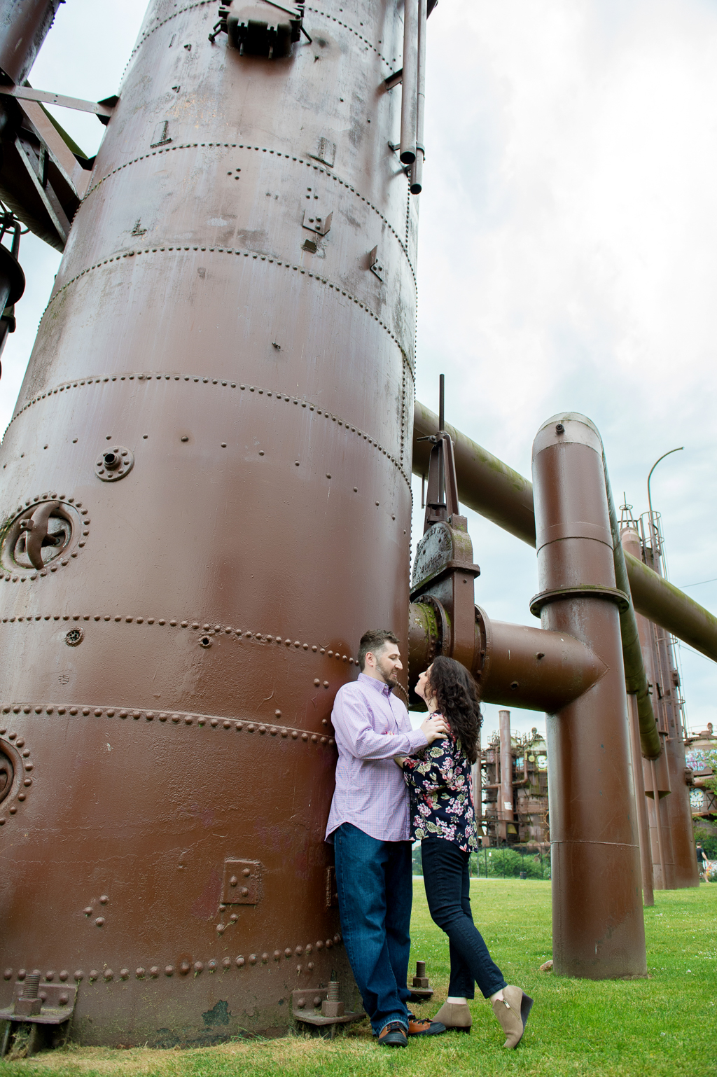 a couple leans against the structures at gas works park