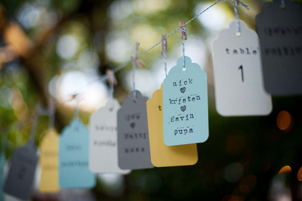 seating tags hang from a string for wedding guests