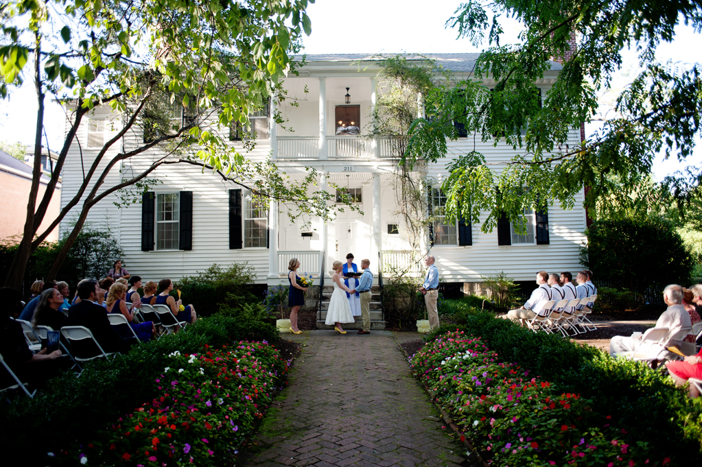a wedding ceremony takes place in front of haywood hall