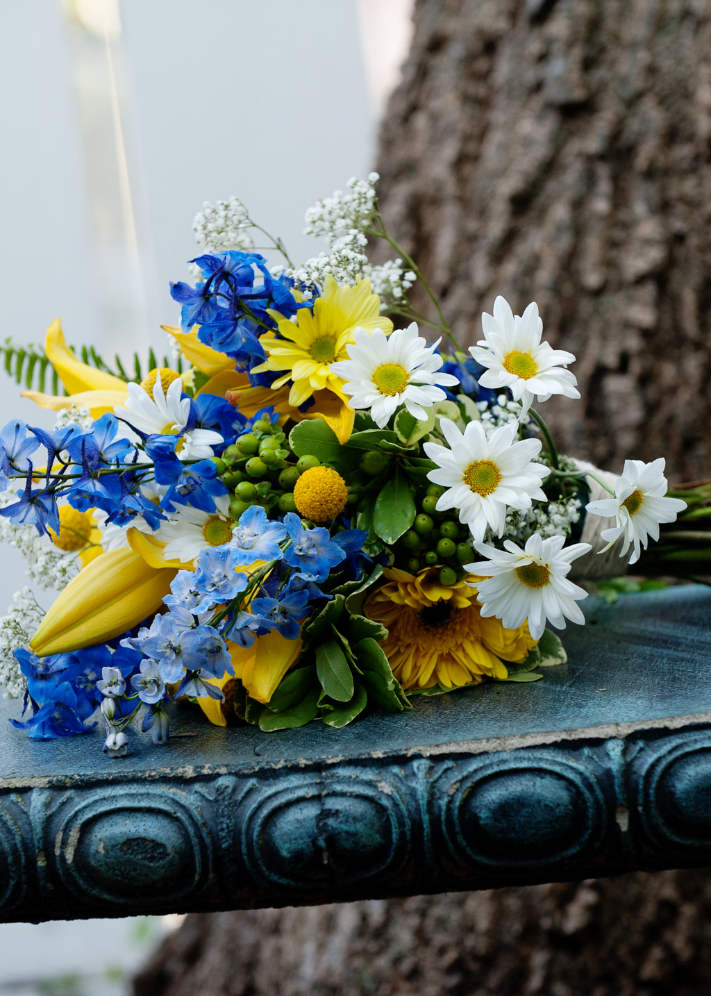 a vibrant blue and yellow bouquet with daisies
