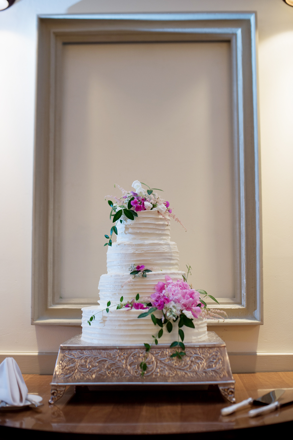pretty white wedding cake with pink flowers