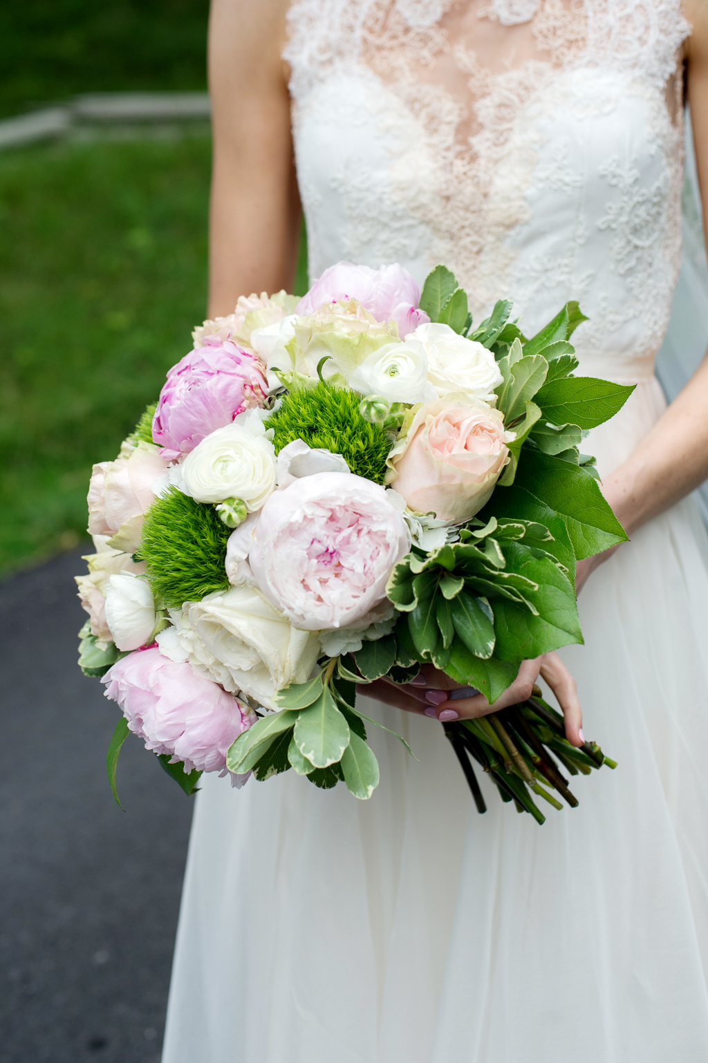 bride holds pretty pink and ivory bouquet