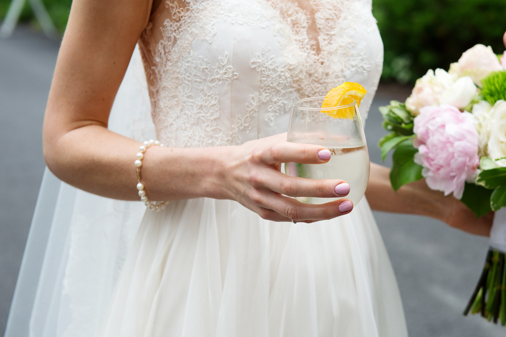 bride holds pretty wedding cocktail