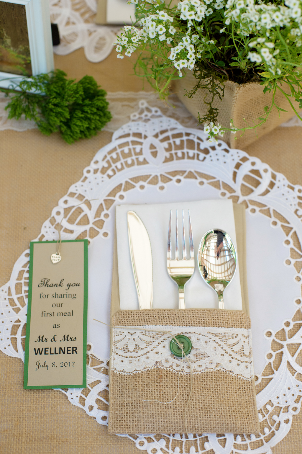 burlap pockets hold dinnerware utensils for wedding