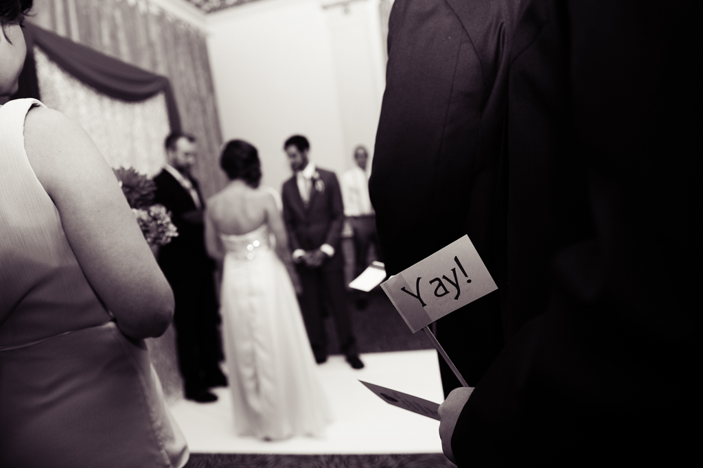 wedding guest has a flag that says yay! in his pocket