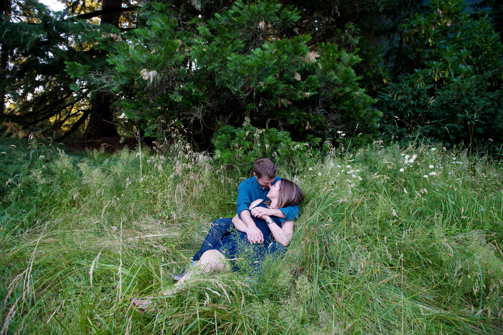 a couple cuddles in the tall grass at hoyt arboretum