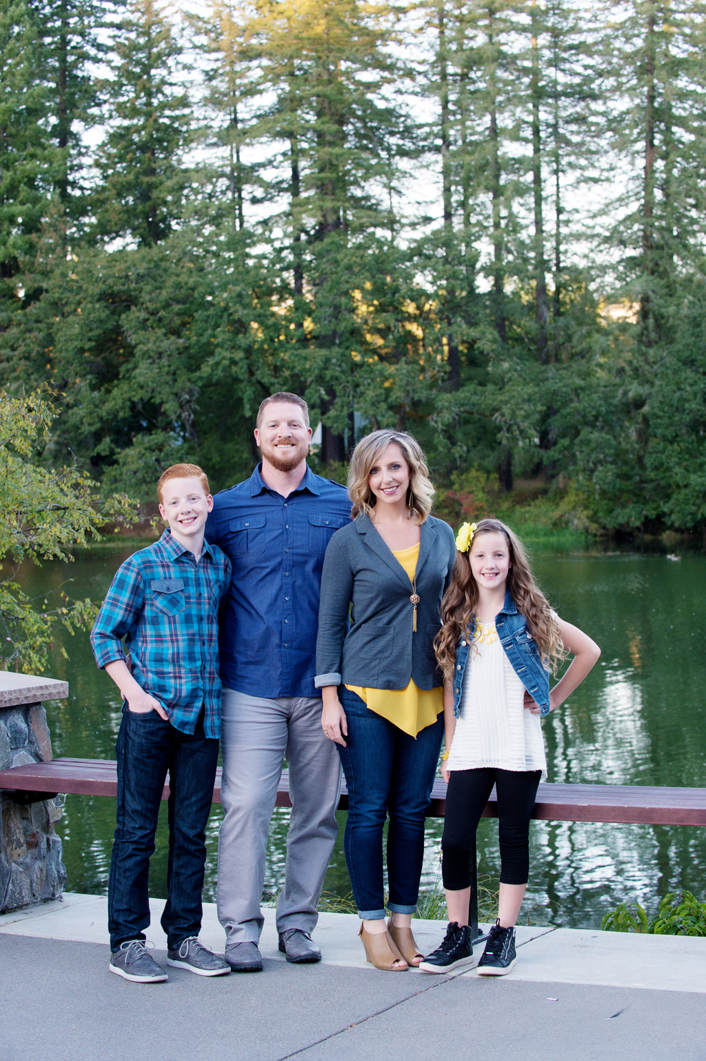 a family in yellow and blue stand in front of lacamas lake