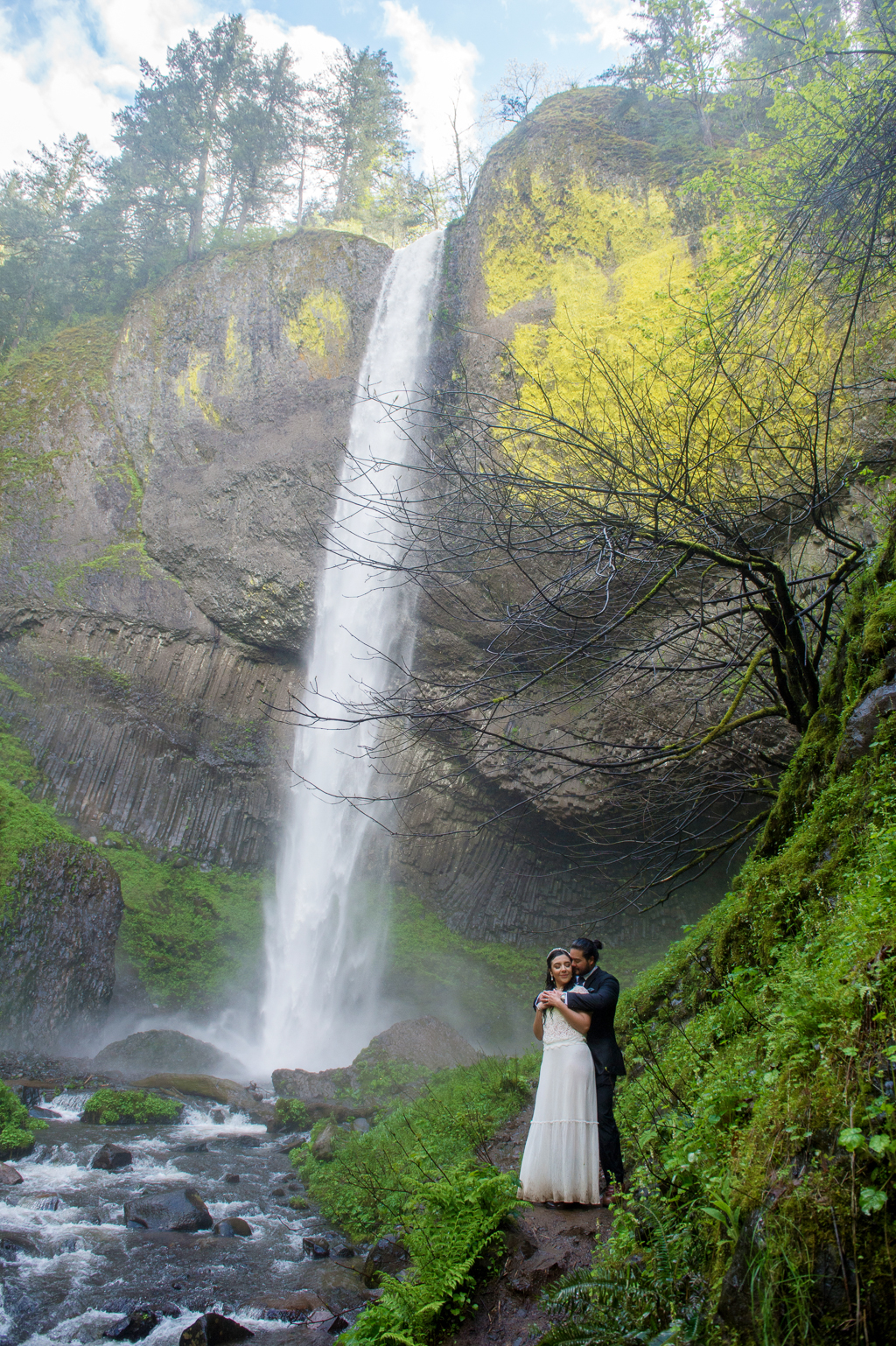 bride and groom embrace under latourell falls