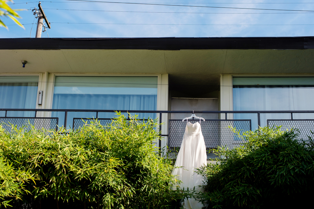 a wedding dress hangs from the balcony of the jupiter hotel
