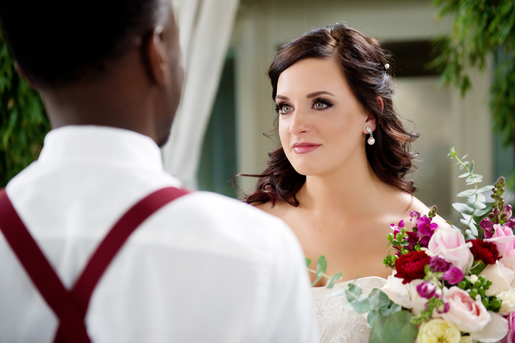 a bride looks lovingly at her groom