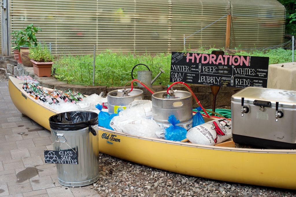 a canoe is filled with ice and kegs of beer for a wedding reception