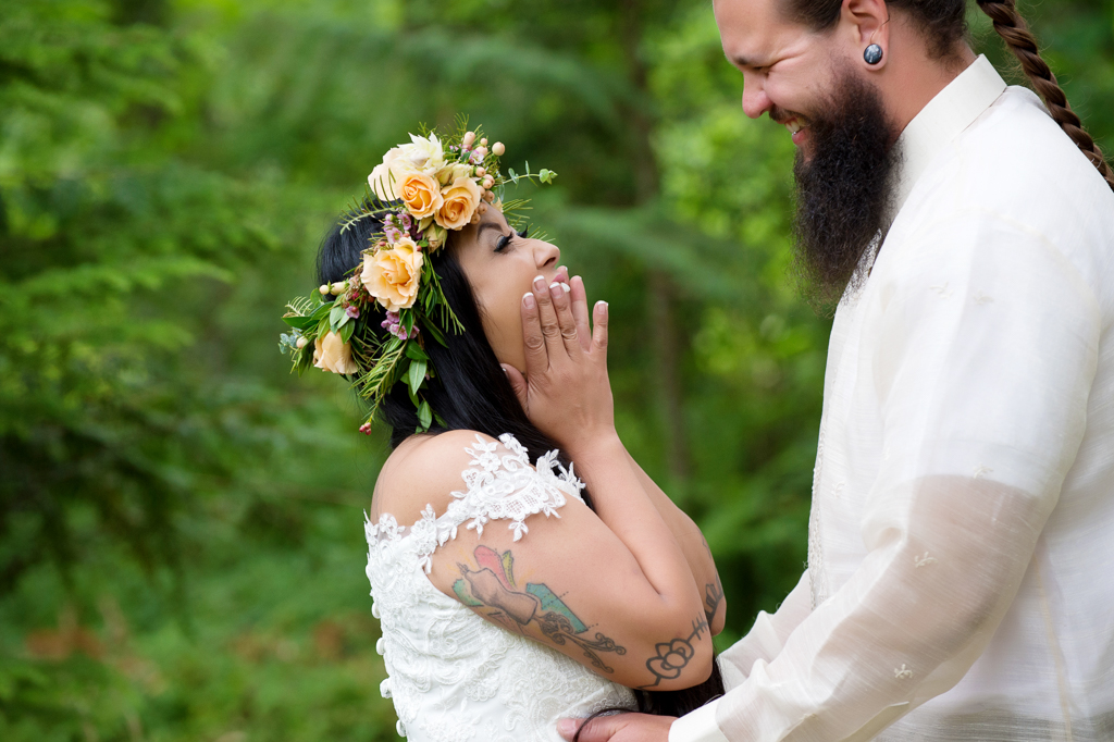 a bride wearing a yellow flower crown excitedly sees her groom