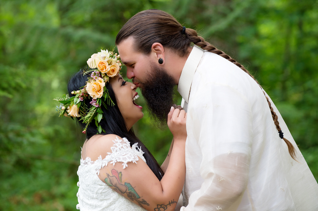 a from with a long braid gives the bride wearing a yellow flower crown a kiss on the nose