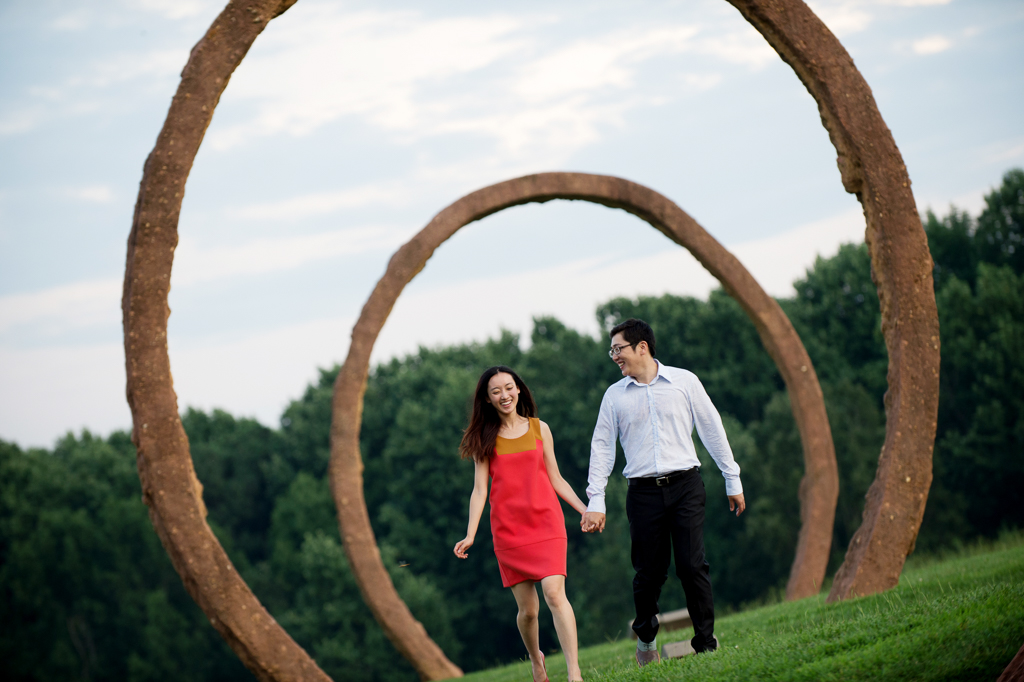 a couple runs underneath the giant sculpture rings at ncma