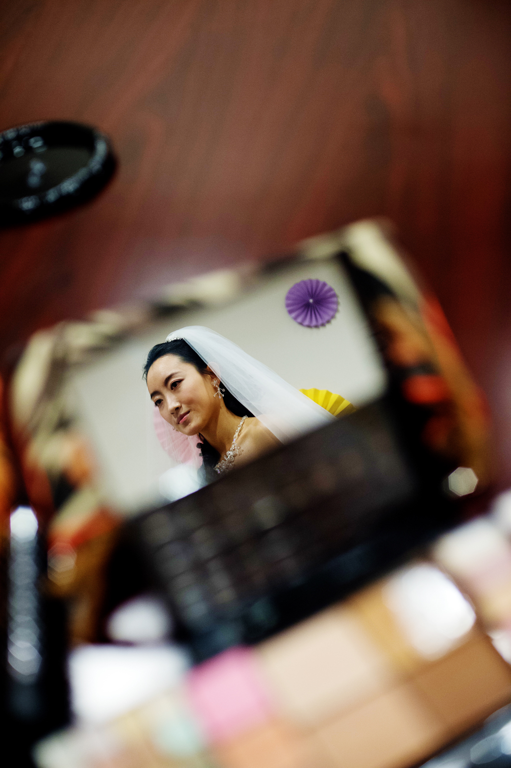 a bride is seen through the mirror on a makeup palette 