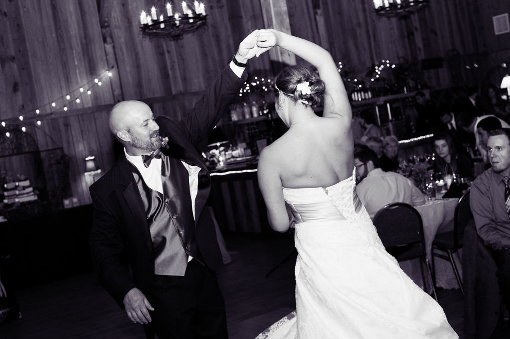 groom leads bride during first dance