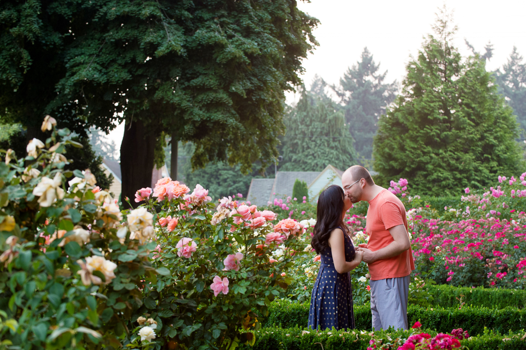 a couple kiss in the rose garden