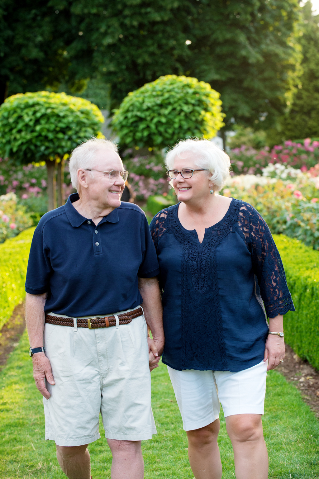 grandparents walk hand in hand through peninsula park rose garden