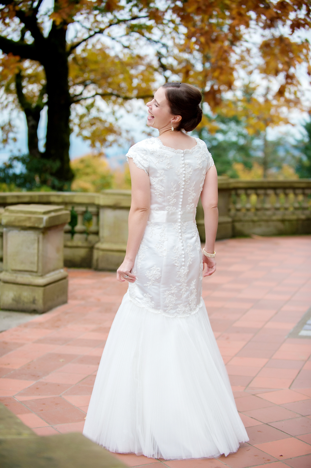 colorful fall leaves surround bride at pittock mansion