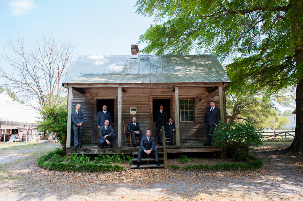 groomsmen sit on front porch of old plantation cabin