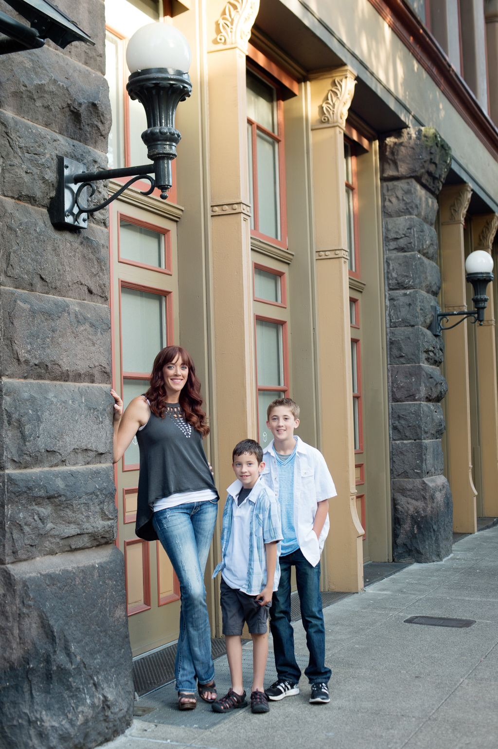 a mom with her two sons stand by a building in old chinatown